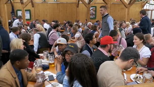 Lidé u stolu oslavit Oktoberfest v velké pivní bar na ulici. Bavorsko, pomalý pohyb — Stock video