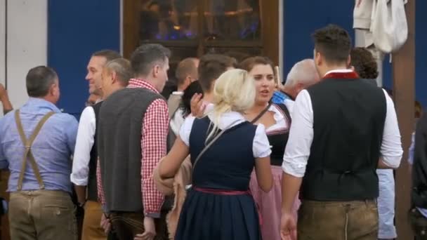 People in national Bavarian suits on the street of Oktoberfest festival. Bavaria, Slow Motion — Stock Video