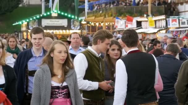 People in national Bavarian suits on the street of Oktoberfest festival. Bavaria, Slow Motion — Stock Video