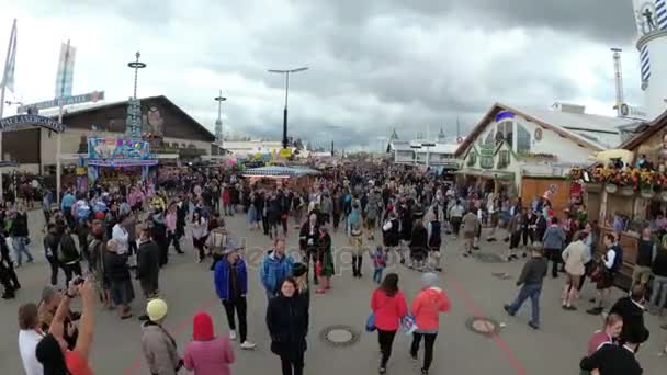 Camera moves from above Crowd of People on central street of the Oktoberfest festival. Bavaria, Germany — Stock Video