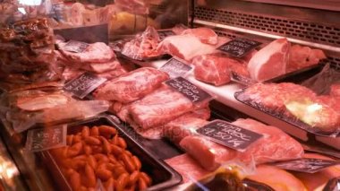 La Boqueria kasap dükkanında kasetlerine fiyat etiketleri ile taze çiğ et. Barcelona. İspanya