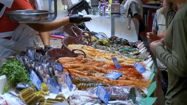 El comprador le da dinero al vendedor para comprar comida marina en La Boquería. Barcelona. España — Vídeos de Stock