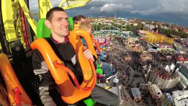 Emotions of people sitting on Sky fall Tower attraction in free fall down on Oktoberfest. Bavaria. — Stock Video