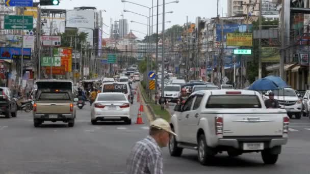 Motos e carros dirigem ao longo das estradas asiáticas. Ruas tailandesas cheias de trânsito. Tailândia, Pattaya — Vídeo de Stock