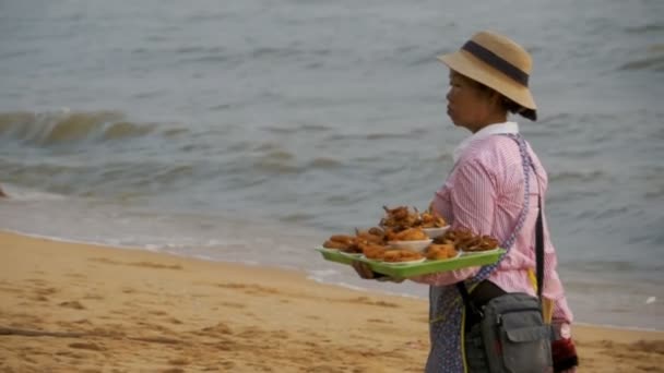 Ázsiai szállító nő hordozza trópusi élelmiszer értékesítési a parton. Pattaya, Thaiföld — Stock videók