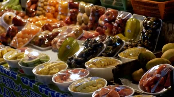 Frutas en recipientes de plástico en un escaparate en el mercado de alimentos nocturnos de Jomtien. Pattaya, Tailandia — Vídeo de stock