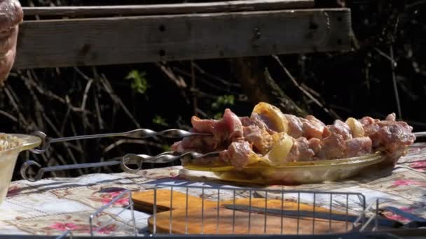 Spieße mit mariniertem rohen Dönerspieß auf dem Tisch im Dorf — Stockvideo