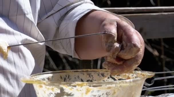 Kövér ember helyezi a nyers pácolt hús nyárson egy Shish Kebab, a természet. Lassú mozgás — Stock videók