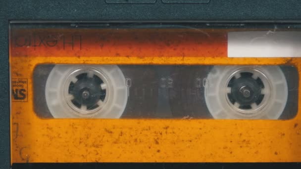 The Vintage Yellow Audio Cassette in the Tape Recorder Rotates — Stock Video