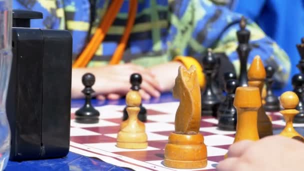 Chessboard and figures. Competitions in checkers among children — Stock Video