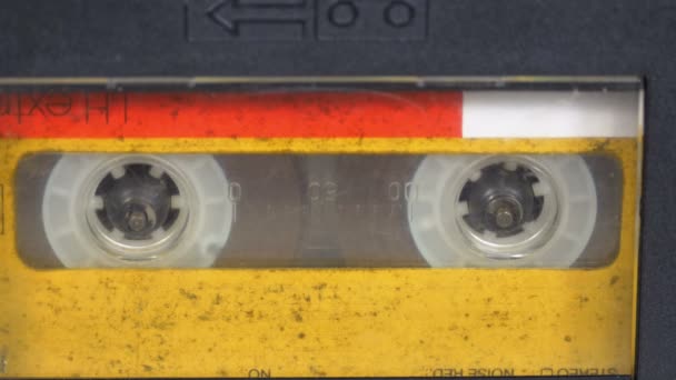 The Vintage Yellow Audio Cassette in the Tape Recorder Rotates — Stock Video