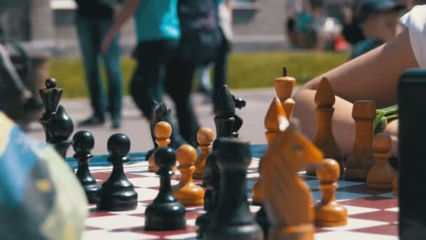 Chessboard and figures. Competitions in checkers among children — Stock Video