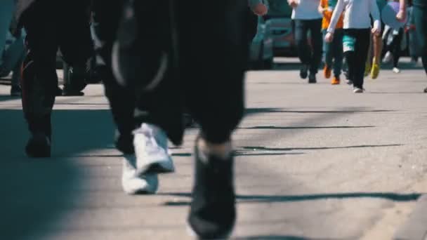 Gambe folla di persone e atleti corridori corrono lungo la strada in città — Video Stock