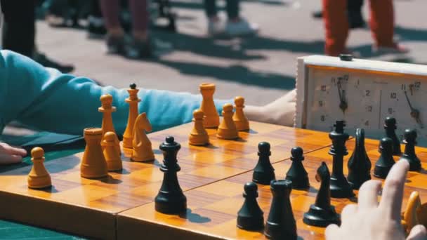 Chessboard with chess clock and figures. Competitions in checkers among children — Stock Video