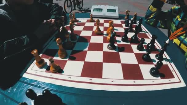 Chessboard and figures. Competitions in checkers among children — Stock Video