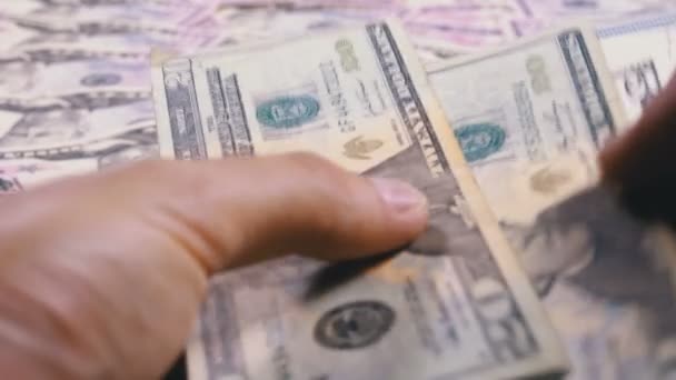 Mens Hands Hold a Pile of American Dollars against the Background of Rotating Money — Stock Video