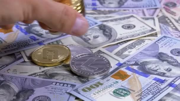 A mão coloca as moedas criptografadas de diferentes moedas em uma mesa com dólares americanos — Vídeo de Stock