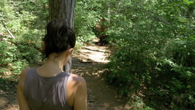 Arkasından görünümüne Traveler kadın Hiking dağ orman iz yolda