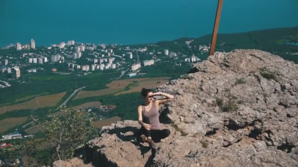 Traveler Woman Sits on Top of a Rocky Mountain — Stock Video