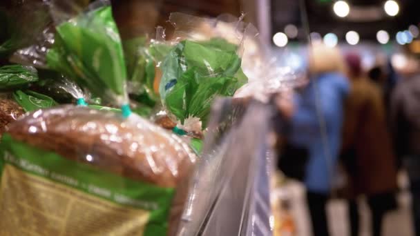 Rows and Shelves with Various Bread in the Supermarket. Buyers Choose the Goods — ストック動画