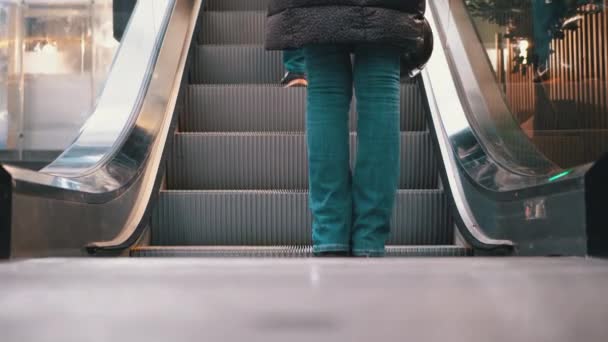 Piernas de gente moviéndose en un elevador de escaleras mecánicas en el centro comercial. Compradores Pies en escalera mecánica en el centro comercial — Vídeos de Stock