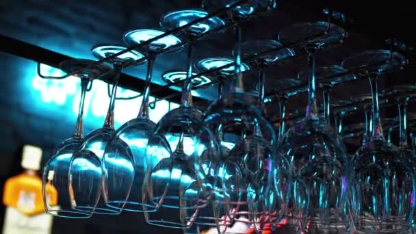 Clean Wine Glasses Hanging Upside Down above a Bar Rack in Restaurant — Stock Video