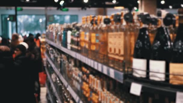 Sprzedaż alkoholu w supermarkecie. Wiersze i półki butelkowanego alkoholu w okienku sklepowym — Wideo stockowe