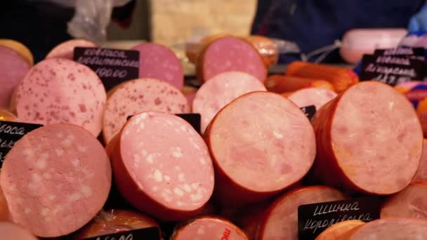 Sausages with Price Tags on the Showcase in the Store. Sellers Stand behind the Counter in the Supermarket — Stock Video