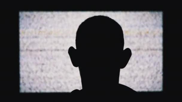 Silhouette of an Anonymous Mans Head is Watching White Static Noise and TV Interference — ストック動画