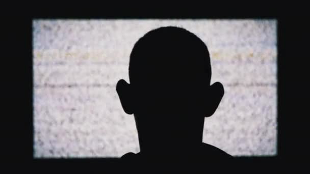 Silhouette of an Anonymous Mans Head is Watching White Static Noise and TV Interference