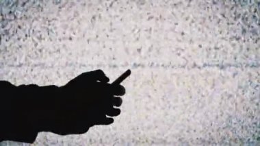 TV ekranında Beyaz Statik Gürültülü Akıllı Telefonu Tutan Bir Elin Silueti