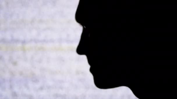 Profil Silhuett av en manlig ansikte på en TV-skärm med vitt buller och interferens bakgrund. — Stockvideo