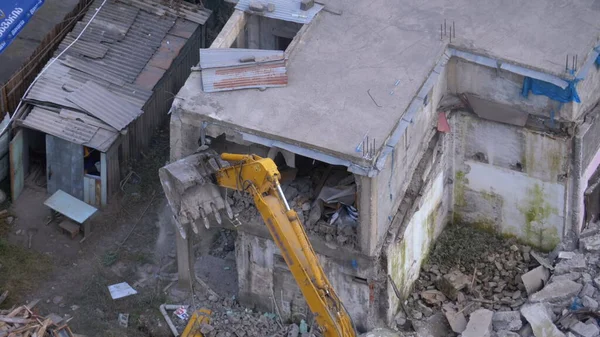 Destroying Old House Using Bucket Excavator on Construction Site.