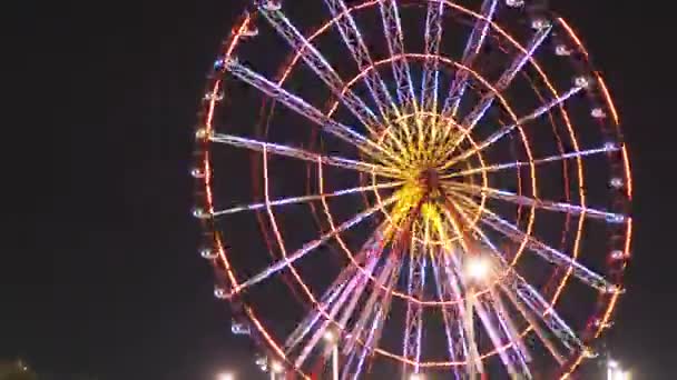Ferris Wheel nära fyren roterar på natten på Batumi bankment — Stockvideo