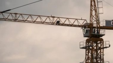 Tower Crane on a Construction Site on a Clouds Backdrop. Timelapse.