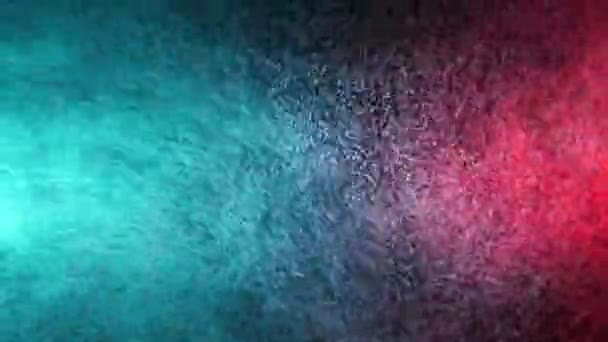 Pulvérisation d'eau verte et rouge mélangée sur un fond noir. Mouvement lent 