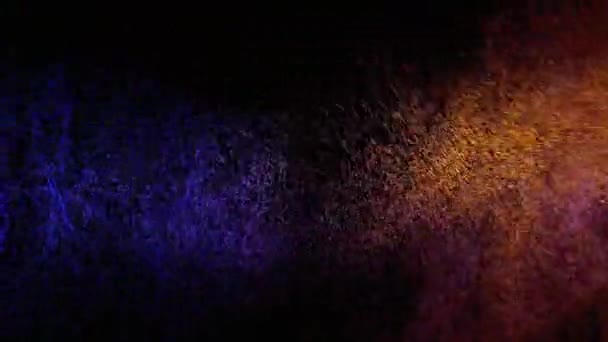 Spray d'eau bleu et jaune mélangé sur un fond noir. Mouvement lent 