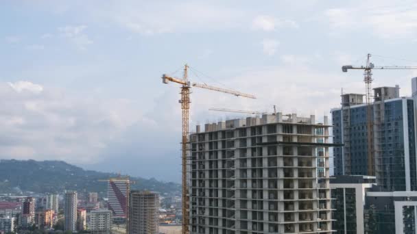 Building Construction. Timelapse. Tower Crane on a Construction Site Lifts a Load at High-rise Building. — 비디오