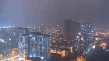 Night City with Skyscrapers and Luminous Windows at Thunderstorm and Lightning Flashes. Timelapse