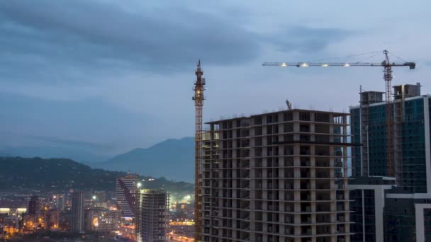 Construção de Construção do Dia à Noite. Timelapse. Guindaste de torre com iluminação em um canteiro de obras — Vídeo de Stock