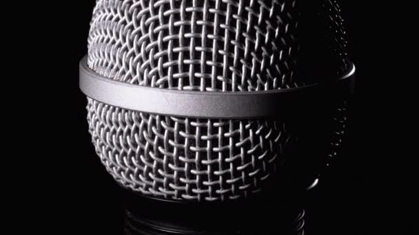 The Microphone Rotates on a Black Background. Dynamic Microphone Grid Spins Close-up — Stock Video