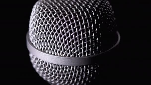 The Microphone Rotates on a Black Background. Dynamic Microphone Grid Spins Close-up — Stock Video