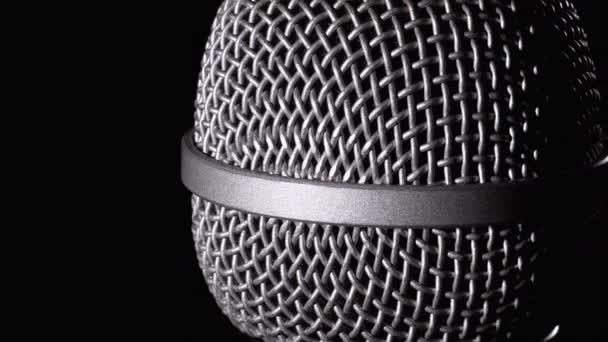 The Microphone Rotates on a Black Background. Dynamic Microphone Grid Spins Close-up — Stock Video