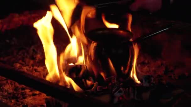 Turk with Coffee is Cooked on Fire while Standing on Coals Embraced by the Tongues of Red Flame — Stock video