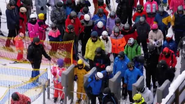 The Queue on the Ski Lift. Crowd of Skiers Stands and Crowds at Turnstile Gates — Stock Video