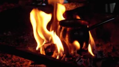 Turk with Coffee is Cooked on Fire while Standing on Coals Embraced by the Tongues of Red Flame