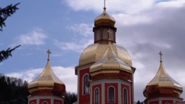 Ukrainian Church with Golden Domes against the Sky and Clouds in the Carpathian Mountains