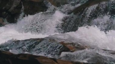 Mountain Creek and Stone Rapids with Snow. Rapid Flow of Water. Winter Waterfall. Slow Motion
