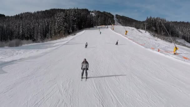 Aerial view Lot of Skiers go Down the Ski Slopes. Drone Flies Low Next to Skiers — Stockvideo