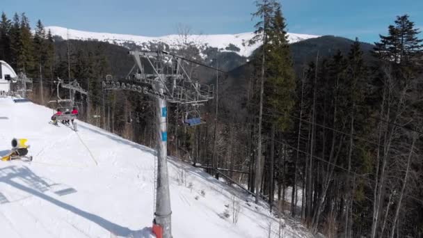 Vista aérea del telesilla para el transporte Esquiadores en la parte superior de la pista de esquí nevada . — Vídeos de Stock